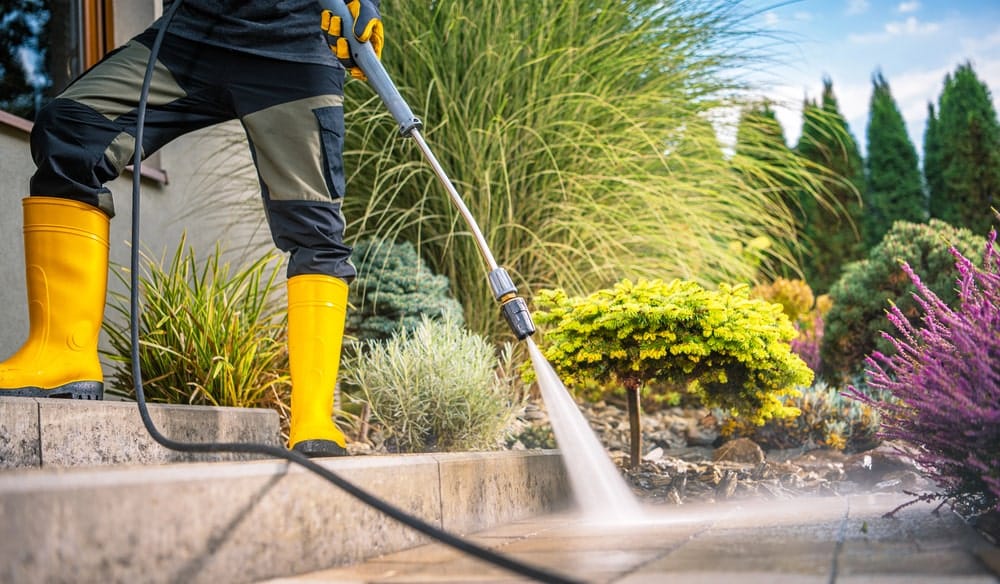 a professional doing pressure washing to a house in surrey & port coquitlam canada