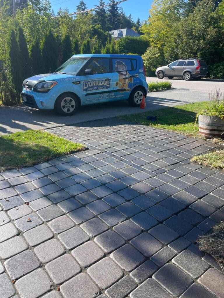 Lyonridge Property Services vehicle parked beside a cleaned and sealed interlocking paver driveway